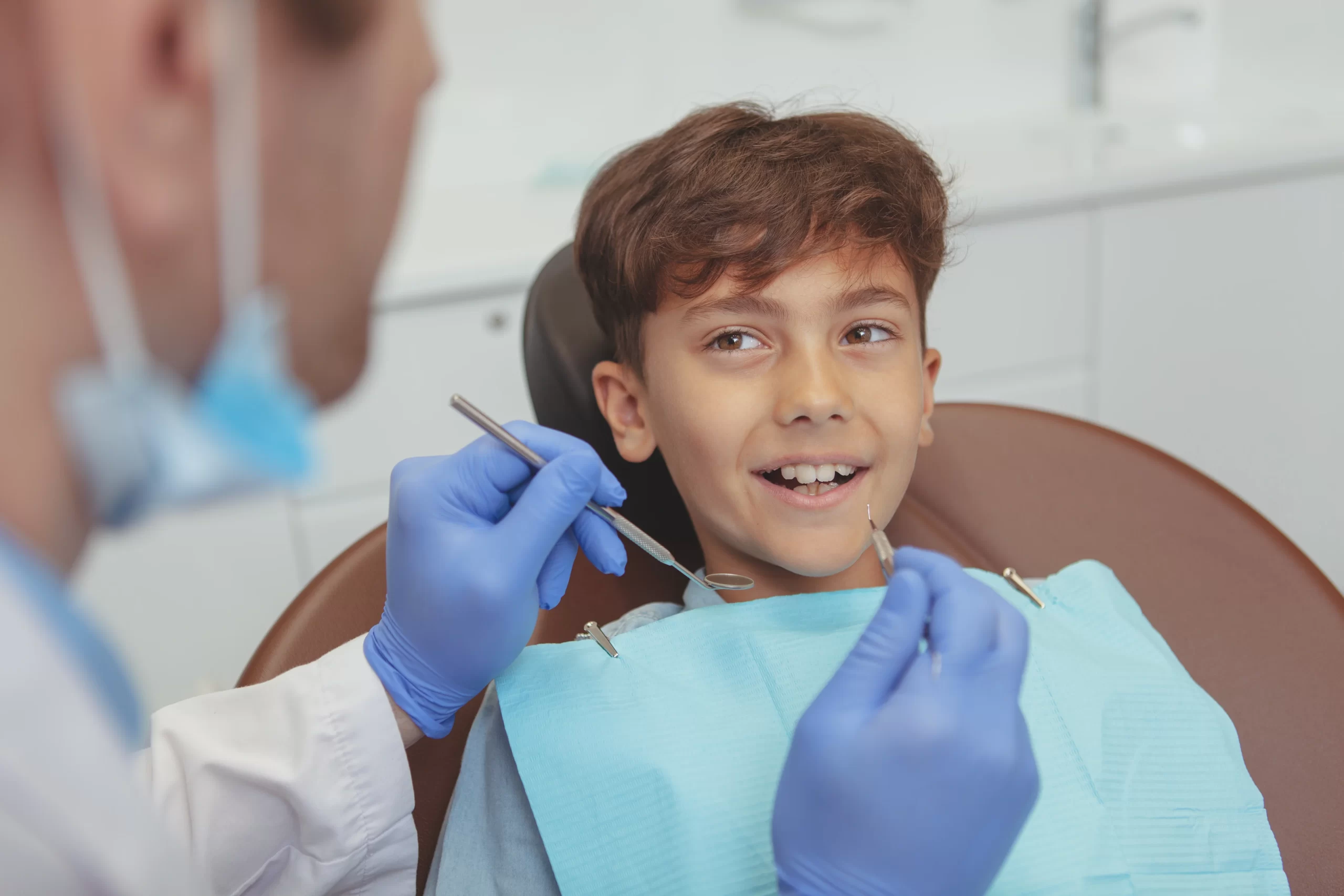 Child smiling during dental check-up appointment.