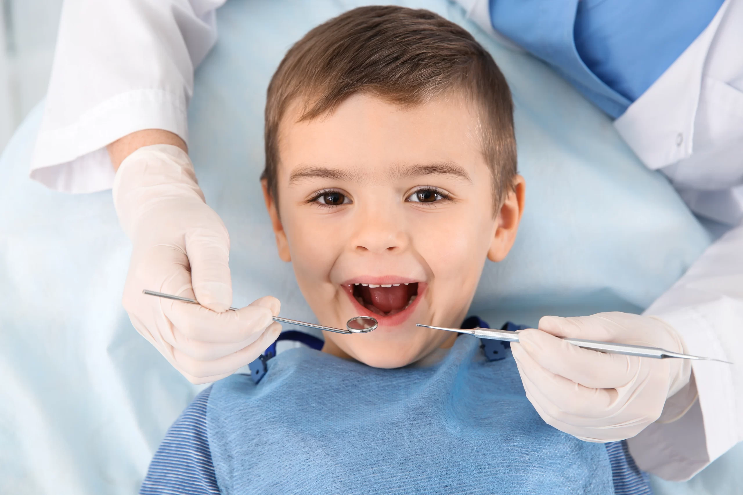 Child at dentist with dental tools. Space Maintainers For Kids