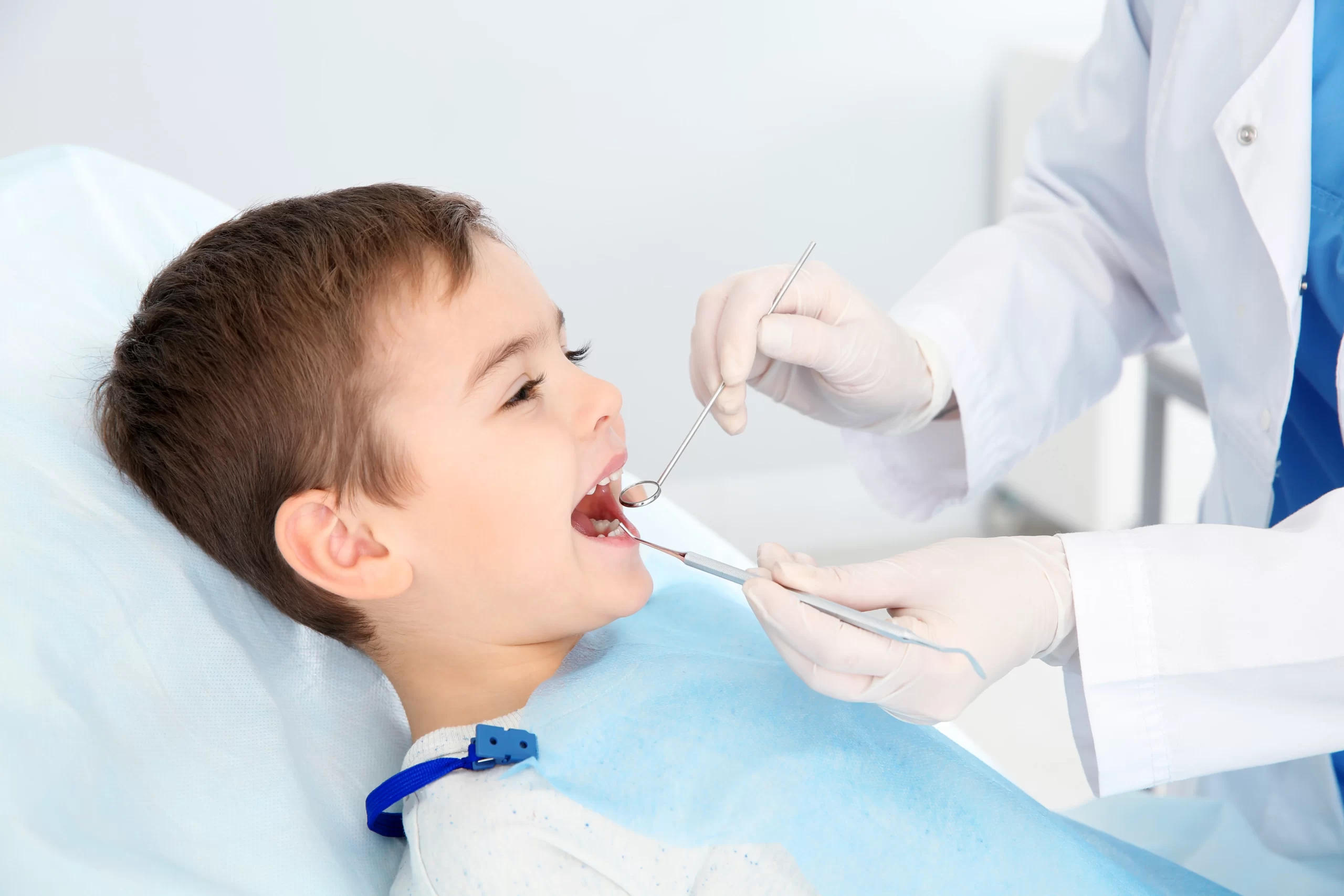 Child receiving dental checkup by dentist.