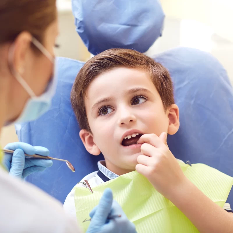 Child at dentist check-up with hygienist.