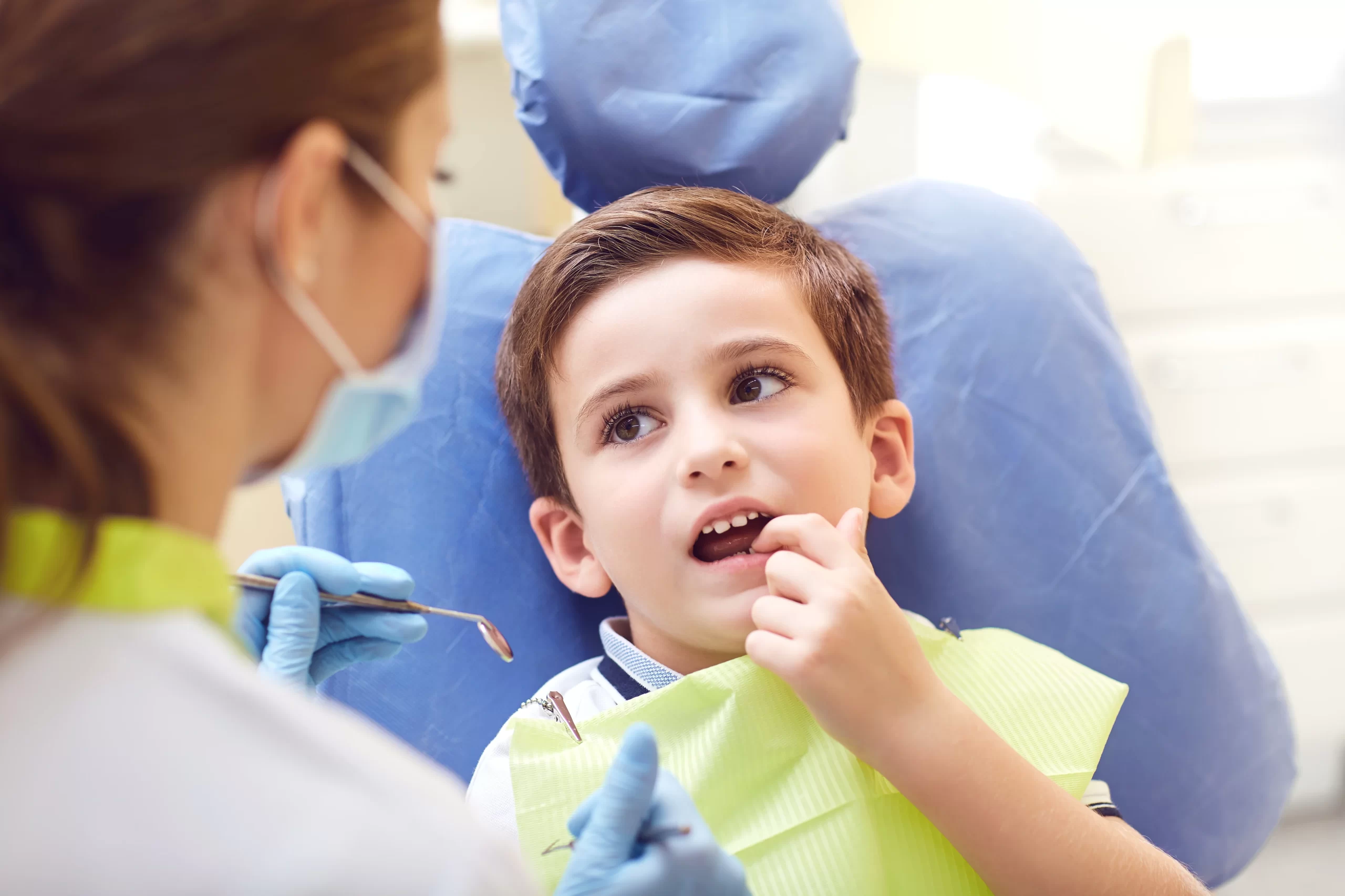 Child at dentist check-up with hygienist.