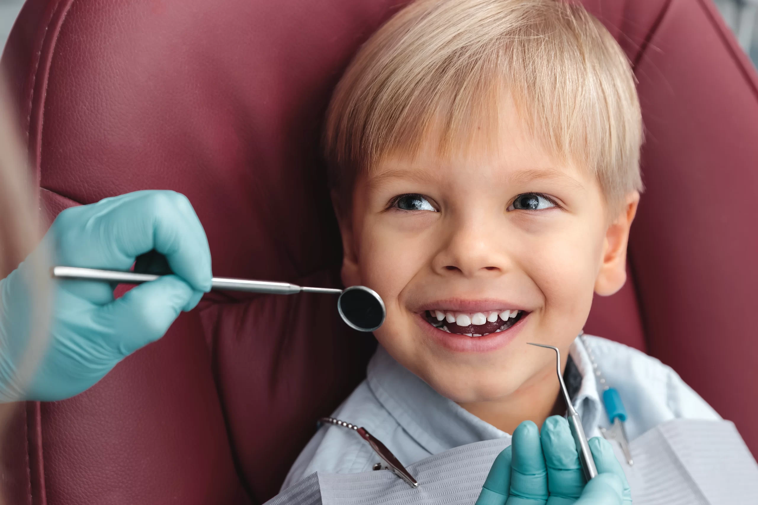 Child smiling during dental check-up after Teeth Extractions For Kids