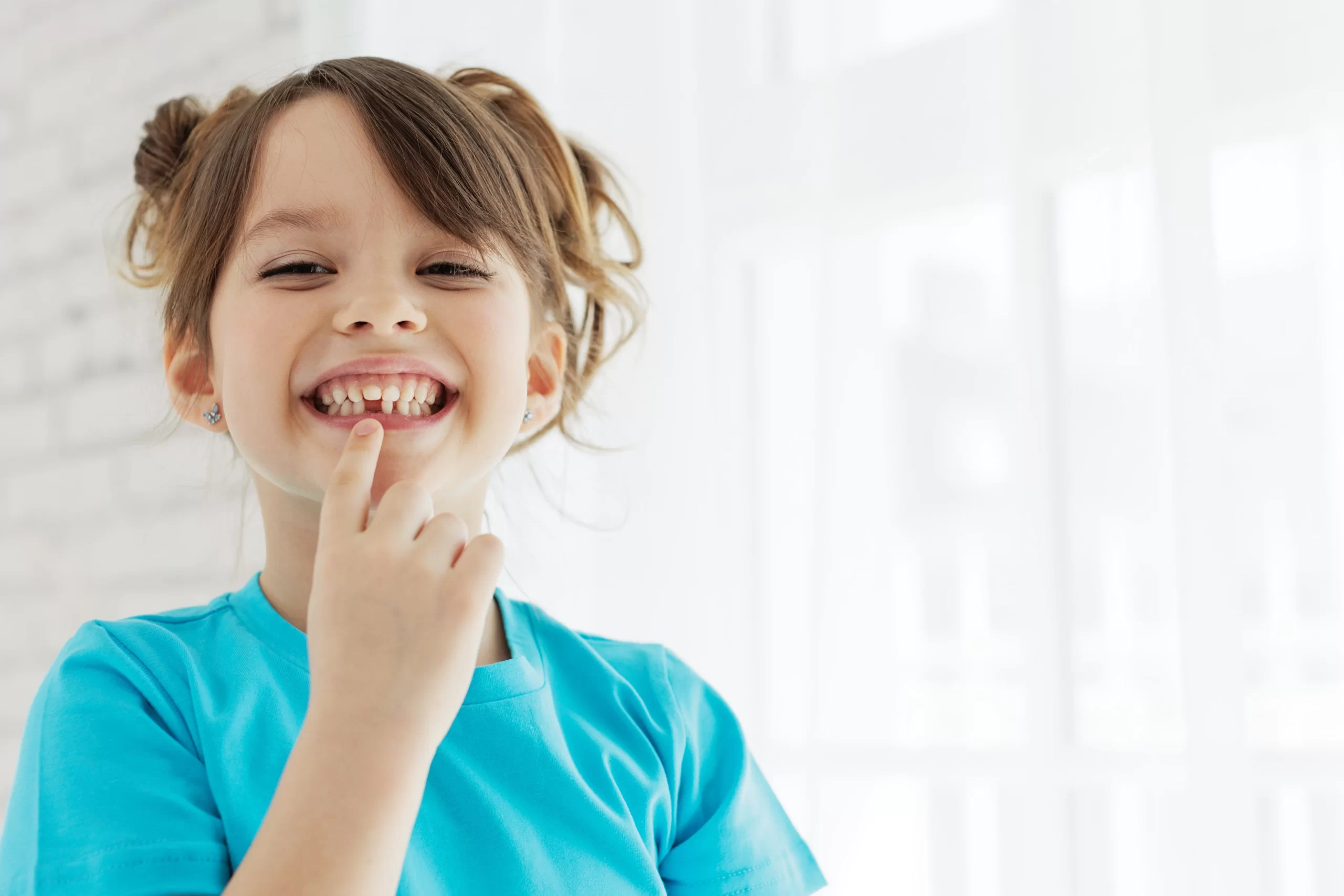 Child smiling with missing tooth