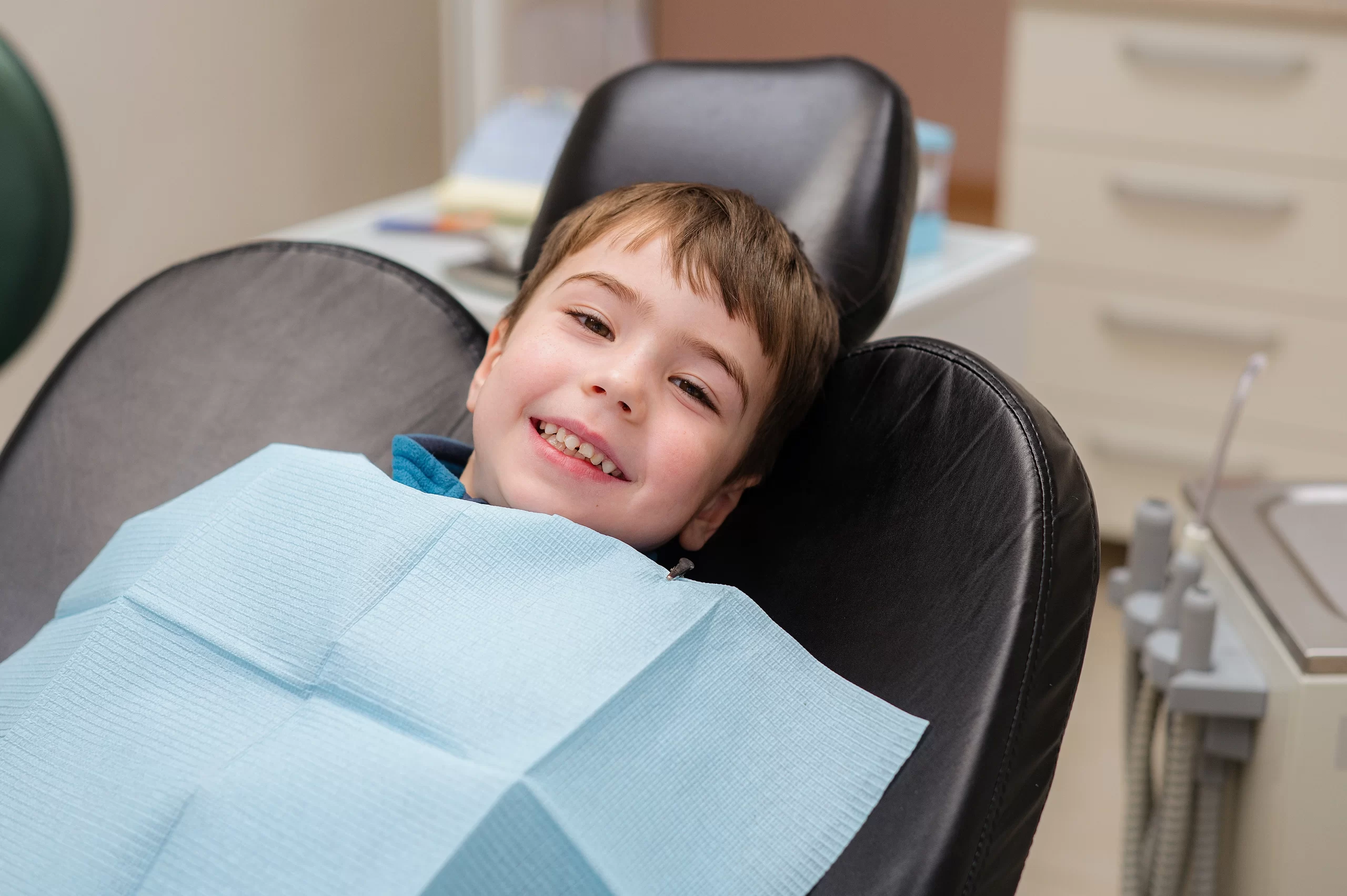 Smiling child sitting in a dental chair.