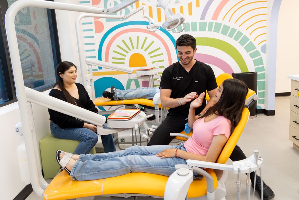 Dentist explaining procedure to patient in soothing environment.