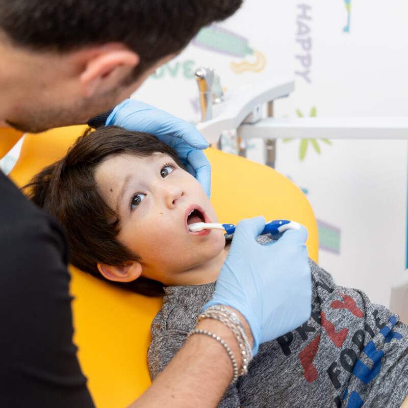 Child receiving dental check-up from dentist.