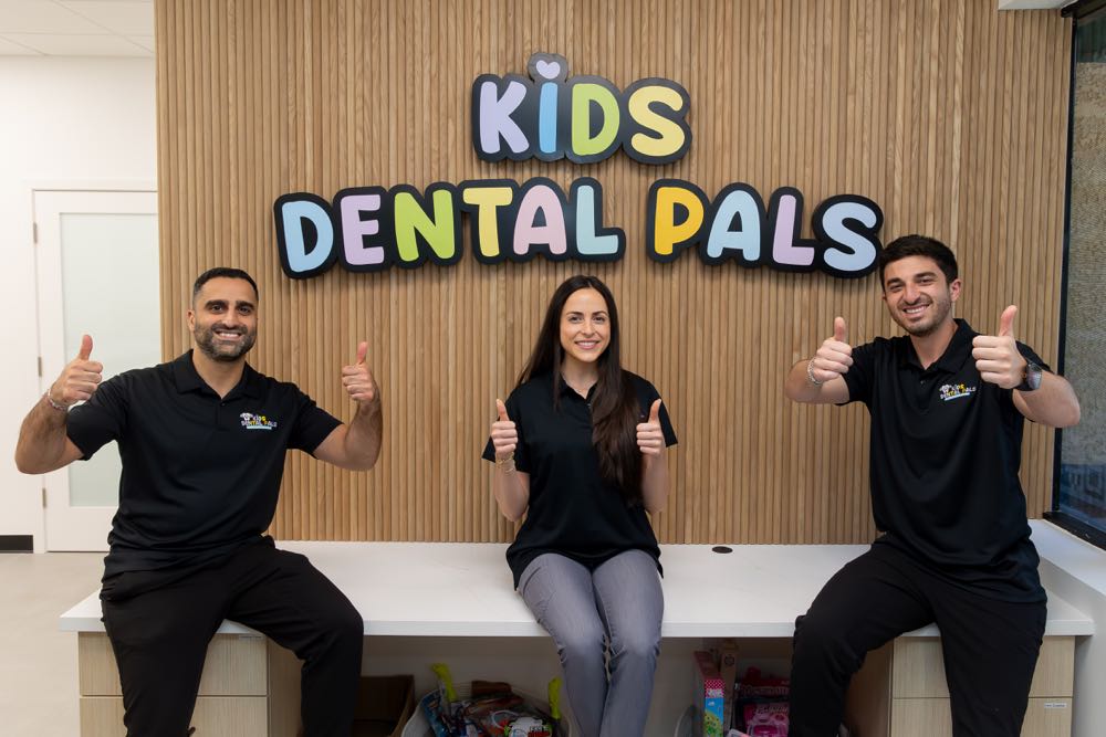 Kids Dental Pals team smiling with thumbs up.