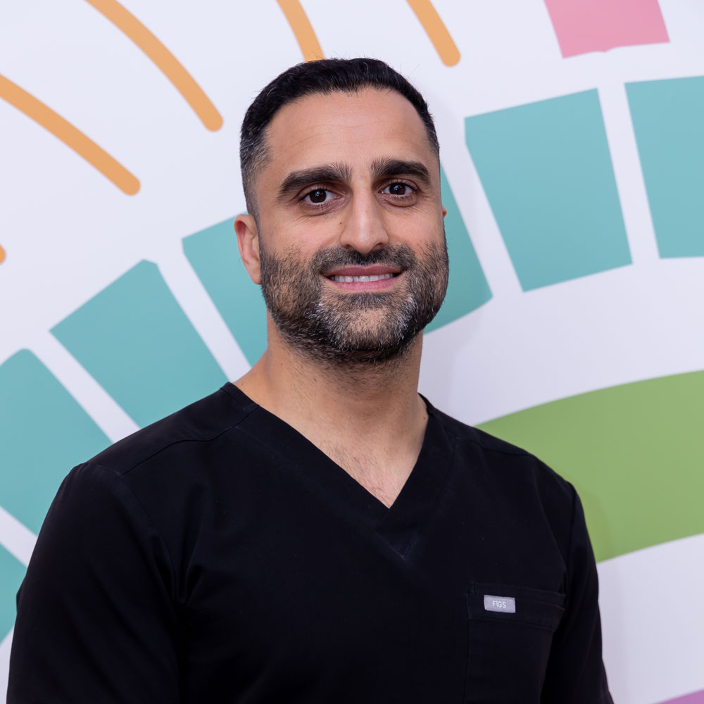 Smiling person in black shirt, abstract background.