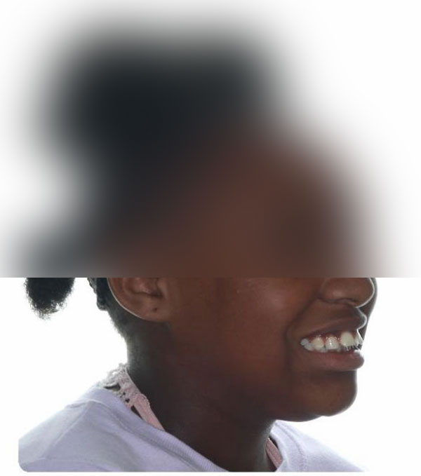 Person smiling with a blurred background.